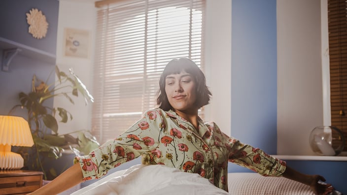 woman stretching in bed